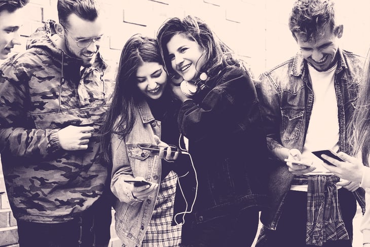 young people looking at mobile ads